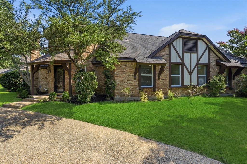 Walk through the front door of 9435 Spring Hollow and step into a time when homes were designed with craftsmanship, charm, and unforgettable character. Unlike anything else in the neighborhood, this enchanting European Tudor-inspired home welcomes you through a distinctive turret entrance featuring antique Texas brick floors and original leaded stained-glass windows that set the tone for the home's timeless appeal.

Inside, rich architectural details abound. The inviting living room is anchored by a beautifully crafted solid wood antique fireplace surround and a wet bar, creating a warm and welcoming space that's equally suited for quiet evenings or entertaining guests. The French doors open to the backyard, seamlessly blending indoor and outdoor living.

The newly renovated kitchen blends modern convenience with classic style, featuring new double ovens, a gas cooktop, sink, dishwasher, disposal, and a generous butcher block island that offers the perfect gathering place for family and friends or an ideal workspace for the home chef.

Natural light pours through the home's new windows, filling each bedroom with warmth and creating bright, inviting spaces throughout. The spacious primary suite is a peaceful retreat with French doors opening directly onto the lush backyard, inviting the outdoors in.

Upstairs, a generous second living area offers endless possibilities as a game room, media room, home office, or library. Step onto the private balcony and unwind beneath the canopy of mature trees with your favorite evening beverage.

Outside, the beautifully landscaped grounds and mature oaks provide both shade and privacy, creating a serene setting that feels worlds away while remaining close to everything.

Lovingly maintained by the same owners for more than 50 years, this is more than just a house—it is a home filled with history, character, and memories, ready for its next chapter.