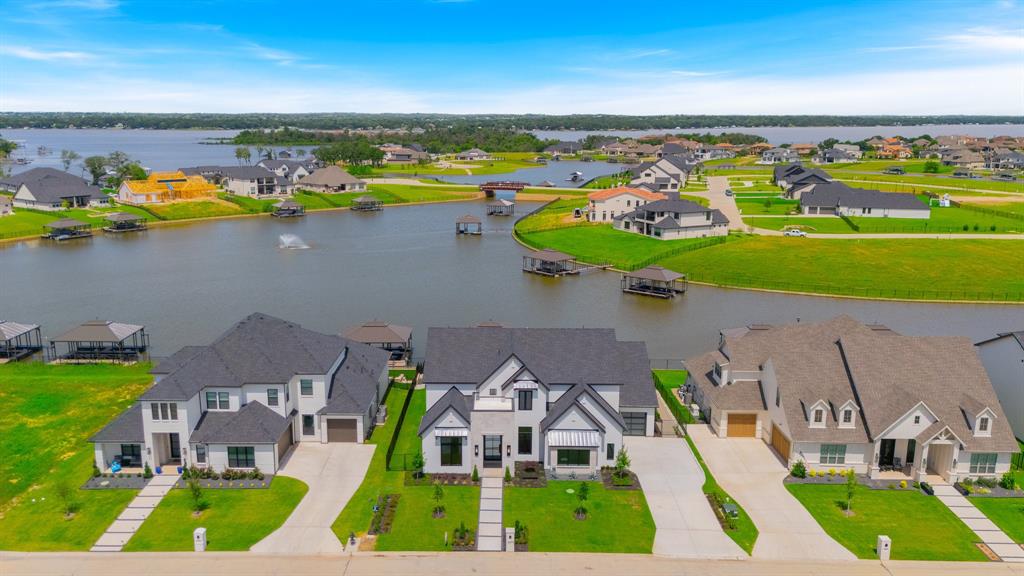 This stunning executive home is located in the highly sought-after community of The Resort on Eagle Mountain Lake. Backing to a tranquil canal with direct lake access, this property offers the ultimate in luxury living. Boasting 5 spacious bedrooms, each with its own ensuite bath, this home is designed for both comfort and privacy. The first floor features the expansive main living area with an open-concept layout, seamlessly connecting to the back patio with the beautiful pool and enjoying the canal views. The primary suite and three additional bedrooms are also located on the first floor. Upstairs, you'll find a large game room and two more bedrooms. This home also comes with a private dock, making it a true lakeside retreat. A must-see property that won’t last long!