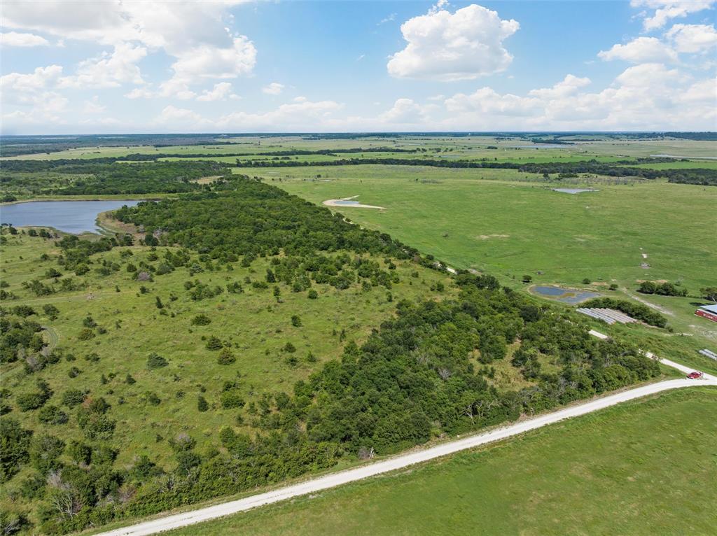 Discover the ultimate retreat with 18.45 acres of pristine land nestled just outside of Coolidge, Texas. This expansive property is a haven for outdoor enthusiasts, offering a blend of dense woods and a serene open space perfect for recreational pursuits such as camping, hunting or building a homestead. Featuring dual-sided road frontage, allowing potential for subdividing or multiple entry points for personal use. Additionally, this property adjoins the community access to conservation reservoir 17, offering unparalleled opportunities for fishing, canoeing, or simply enjoying the serene water views - catering to those with a passion for the outdoors and a love for adventure. There is a small tank along with an old barn, that with some TLC, would be perfect for animals. Seize the chance to own this versatile piece of land that offers endless possibilities for recreation and relaxation. Whether you're envisioning a private retreat or exploring development potential, this property is brimming with opportunity.
