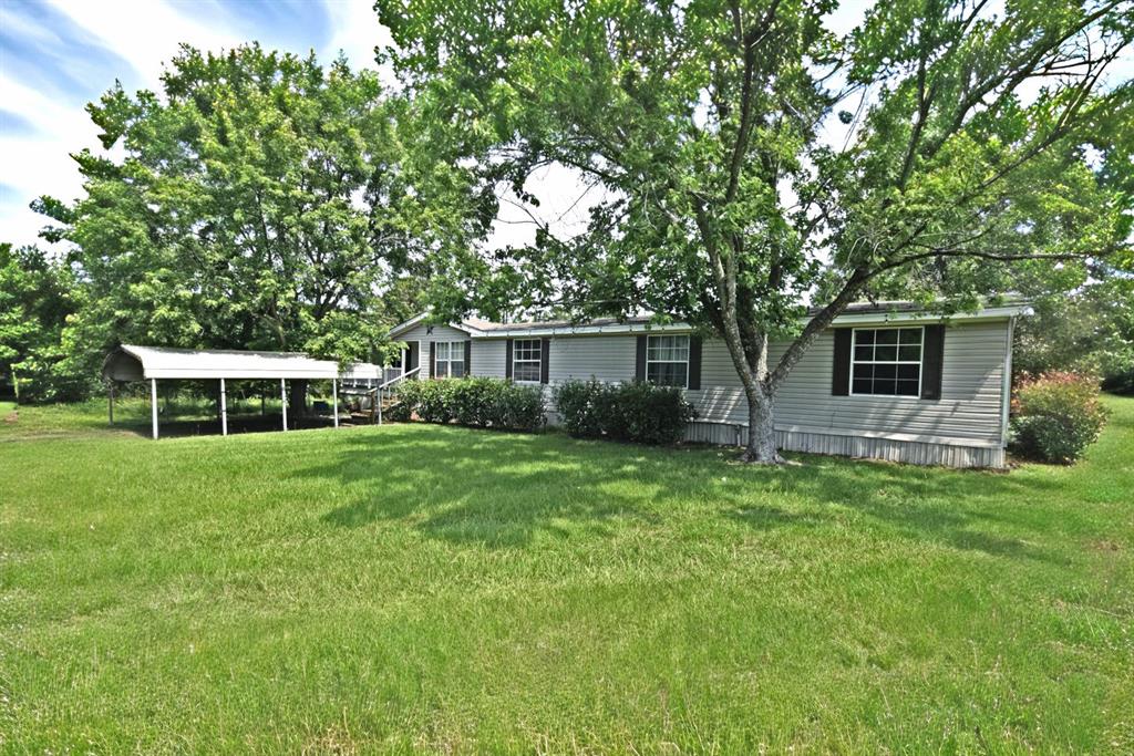 Here is the perfect home for your large family! Sitting on 1.33 acres, this mobile home features 6 bedrooms, 3 bathrooms, a wood burning fireplace, dining area, kitchen with center island and a large utility room, plus a 5’ x 20’ covered front porch. Property has a 24' x 20' double carport in front and a metal, half open carport for your boat out back. Next to this carport there is a storage shed with shelving or make yourself a workshop. Plus, an additional storage building closer to the home. This mobile home is sitting in its original location since new and should be eligible for any FHA, VA or USDA finan'cing. Property is mostly fenced with barbwire and has a storm shelter. Boat Ramp to Legendary Lake Fork is approximately 10 minutes from home. This is a great place for that first-time buyer or for those looking to get out of the city and relax. Property has a Yantis address but in Hopkins County with Sulphur Springs ISD. Buyer to verify any and all information.