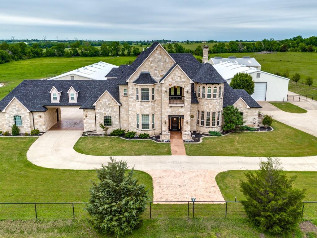 Exquisite luxury estate nestled on 15 unrestricted & ag exempt acres in the heart of Collin County! The 6,333 sq ft home is the epitome of comfort & elegance. Step into the gourmet kitchen, a culinary masterpiece boasting a butlers pantry, granite countertops, an island w a second sink, double convection ovens, dual dishwashers, & a gas cooktop complete w griddle & deep fryer. The living room is a sanctuary of comfort and style, featuring a striking floor to ceiling stone wood burning fireplace & tons of natural light. The spacious primary suite is located on the first floor & offers a peaceful retreat from the outside world w huge walkin closet & a luxurious primary bath featuring double sinks, a vanity area & an oversized walkin shower. There is a library & guest suite downstairs as well as 3 additional bedrooms, gameroom, gym area, a play room, a loft & 2 balconies on the second level! Amenities include: a 60X60 metal barn w 8 stalls, 2 more steel framed buildings, &  9ft pond!