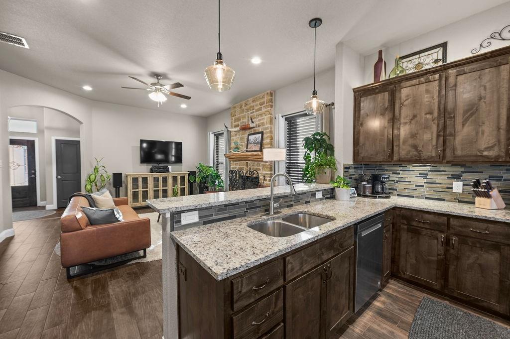Located in Godley Heights, where the homes are situated on generous size lots with space between neighbors. 
Pride of ownership shines with this handsome 1 story home offering 3 bedrooms, 2 full baths, an open floor plan, and 2 car garage. Flooring throughout all the main living areas is wood-look tile, knotty alder cabinetry, stainless kitchen appliances with a center island. The rock fireplace in the family room is a focal point, including the custom live edge wood mantel. The primary suite accommodates king size furniture and is spacious enough to include a sitting area, walk-in shower with separate soaking tub, dual vanities, water closet, and walk-in closet. The large laundry room includes cabinetry, and folding counter. This home is 4 sides classic masonry with a covered back porch. Clean and move-in ready! Godley ISD and close to schools!