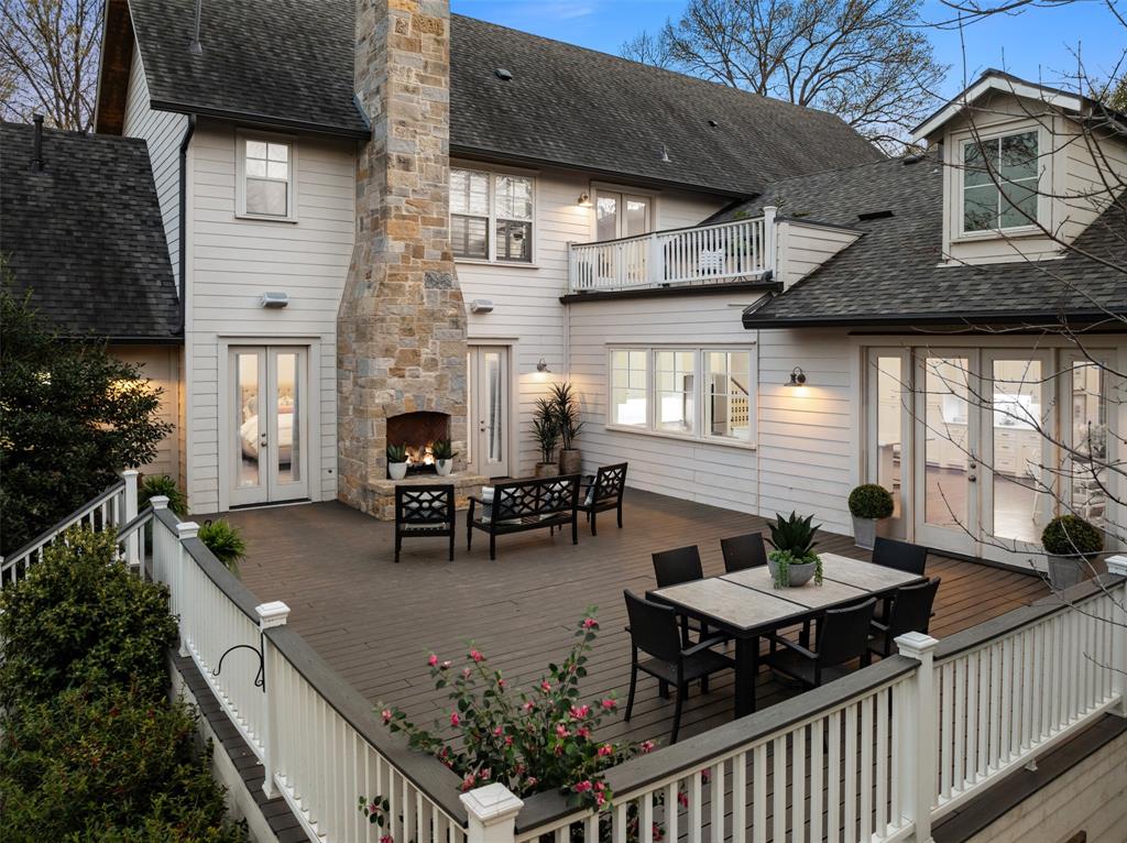 Set on an oversized, tree-filled lot on a country-style lane, this beautifully designed 6-bedroom, 5-bath home offers the ideal blend of space, functionality, and charm in the heart of Bluffview (Shorecrest Estates). Desirable pier-and-beam construction elevates the home above an expansive backyard, complete with a 900+ sf deck for al fresco dining or sitting by the fire. A welcoming front porch leads into generous living space designed for both everyday living and entertaining. The main level features a formal dining room, formal living or study, and a spacious living area that flows seamlessly into the gourmet kitchen. Outfitted with premium Sub-Zero, Dacor and Samsung appliances, a large center island, and ample storage, the kitchen offers a clean, functional layout and sweeping views of the backyard. Tucked privately at the rear of the home, the primary suite offers a true retreat with its own fireplace and direct access to the charming backyard deck. A secondary guest suite is also on the first floor, along with a butler's pantry and fully upgraded laundry room featuring custom cabinetry and new tile. A wall of custom cabinets behind the kitchen provides flexible storage alongside a full beverage center. Upstairs, a spacious second living area, enhanced with a wet bar with fridge, icemaker and dishwasher, opens to the rooftop outdoor deck. Four additional bedrooms and a versatile bonus room, ideal for a media room, playroom, or home office, provide flexibility for a variety of lifestyles and needs. Additional features include Ecobee smart thermostats, app-enabled security system, fully hardwired video monitoring system and a new front fence already wired for an electric gate. Sought-after public and private schools, and the shops and dining of Lovers Ln. are just a short drive away. With incredible outdoor living space in a peaceful, private setting, this move-in-ready home offers an exceptional opportunity in one of the city's most picturesque neighborhoods.