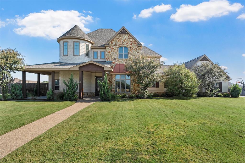 Experience Italian villa–inspired luxury in the gated community of Austin Colony, located within the highly regarded China Spring Independent School District. Situated on .7997 acres of beautifully maintained native Texas landscaping, this exceptional 3,408 sq. ft. estate blends timeless architecture with resort-style living. A dramatic spiral staircase makes a stunning first impression, leading to a flex space at the landing—perfect for a secondary living area, media room, or study nook. Upstairs you’ll find three spacious bedrooms, including two connected by a convenient Jack-and-Jill bath. Downstairs, the private primary suite offers a serene retreat with a large walk-in closet and spa-inspired bath. An additional bedroom and full bath are thoughtfully positioned for guests, along with a versatile flex room ideal for an office, workout space, or sixth bedroom. The open-concept living, dining, and kitchen area is designed for entertaining, all overlooking the covered patio and spectacular pool. Rich stonework, granite countertops, and abundant natural light highlight the home’s elegant character. The chef’s kitchen features double ovens, a gas cooktop, generous prep space, and beautiful stone and granite details. Step outside to your personal backyard oasis. The heated pool showcases a water feature, tanning ledge, and a sauna area for ultimate relaxation. Whether hosting gatherings or enjoying quiet evenings, this outdoor space delivers year-round enjoyment. Additional features include a three-car garage, fabulous laundry room with extensive cabinetry, sink, and counter space, plus countless custom details throughout. Luxury, privacy, and resort-style amenities—all in one remarkable property.