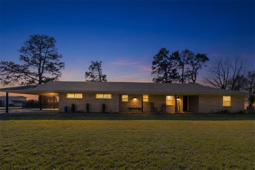Welcome to your own slice of country living! This beautifully updated 3-bedroom, 3-bath home WITH an office offers the perfect blend of comfort, functionality, and true HOMESTEAD potential. Featuring two primary suites, the layout is ideal for multi-generational living or added flexibility for guests. Step inside to find thoughtful updates throughout, including a 2024 tankless water heater, an additional hall water heater, ceiling fans in every room, fresh paint, and a cozy wood-burning fireplace with hidden wood storage. The kitchen is well-equipped with a high-end oven with gas cooktop, refrigerator, and the laundry room offers built-in cabinetry for added convenience. A den AND living room to keep the kids well-entertained as well as the adults! Outside, the property is fully set up for country living with a full concrete driveway, covered attached two-car carport, and a combination of chain link and barbed wire fencing, along with partial electric fencing—ideal for a variety of animals including goats, horses, sheep, and more. The natural setting is highlighted by mature crepe myrtles, black walnut, and pine trees, adding both beauty and shade. Designed with functionality in mind, the land features multiple water access points throughout, making it well-suited for livestock or agricultural use. The 40x40 pole barn with power and water is positioned toward the back of the property, while the impressive 30x70 shop (30x50 enclosed) with electricity and two bay doors provides ample space for equipment, hobbies, or storage. Two additional sheds convey for even more utility. Enjoy peaceful country living surrounded by trees, pasture, and true East Texas beauty, with the added benefit of farm road accessibility and a corner tract location for easy access. Whether you’re looking to start a homestead or simply enjoy wide open space, this property is ready to meet your needs. Property is HS and Ag exempt!