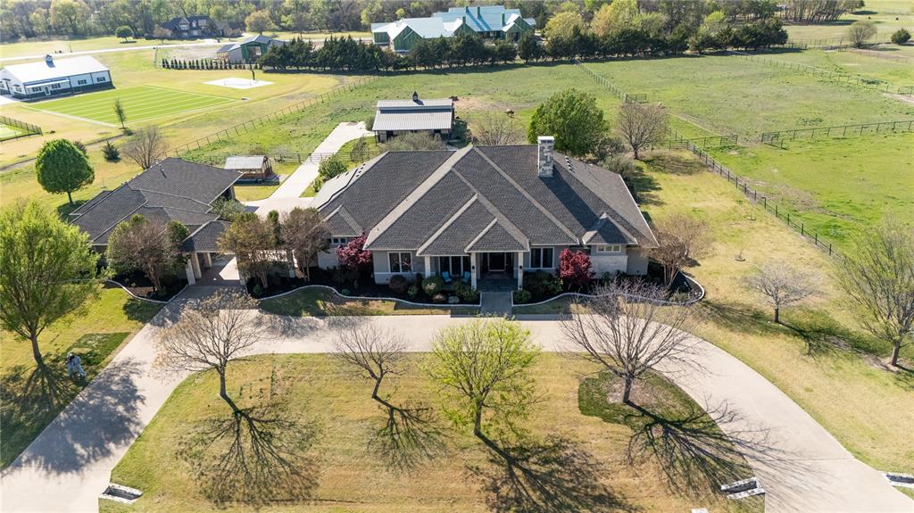 Do NOT MISS this exceptional single-story estate with a GUEST HOUSE, perfectly situated on 4.47 picturesque acres within a desirable GATED community! Offering a RARE combination of space, comfort and versatility, this property is ideal for those seeking both a private retreat and a functional lifestyle! The main home features 4 spacious bedrooms and 3.5 bathrooms, including a Jack and Jill bathroom. Open concept layout flows seamlessly to outside making it perfect for entertaining! All windows have been replaced providing ample natural light and are equipped with motorized shades throughout for effortless living and gorgeous views! Spacious kitchen complete with two islands, two sinks, and a huge walk-in pantry. The spacious primary suite offers a luxurious escape with sitting area, complete with garden tub, oversized shower, and an additional flex room off the primary bath. Fourth bedroom currently being used as a study. Game room complete with built-in desk, shelves & drawers! Spacious laundry with sink and room for extra fridge! Step outside through the large, screened porch and experience a true private retreat with amenities that are truly unmatched! Relax & swim in the Saltwater pool surrounded by lush landscape and peaceful views! Equestrian enthusiasts and hobbyists alike will appreciate the 3 fully fenced pastures including one with its own separate entrance, as well as a well-equipped BARN with four stalls! Space for RV parking for recreational needs. 3 ample spaced pastures allow for animals, sports courts or whatever else you desire! Greenhouse, multiple garden beds, and multiple fruit trees are a garden enthusiasts dream! A SPACIOUS separate GUEST HOUSE fully equipped with 1 large bedroom, 1.5 baths, laundry area, custom built-ins and new matching appliances! Oversized garages equipped to accommodate up to 6 vehicles, and expansive circle driveway offers plenty of parking.  Zoned for highly regarded Prosper ISD schools! This property truly is a gem!