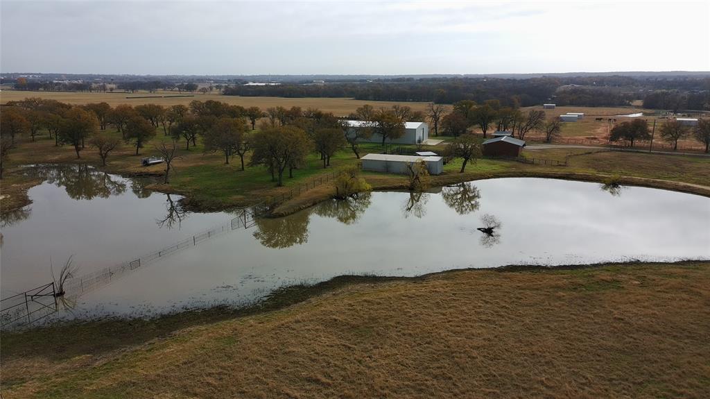 Discover an exceptional 73+ acre ranch property nestled in the heart of Parker County horse country, just south of Millsap. This well-appointed tract offers a rare combination of productive land, quality improvements, and scenic beauty—ideal for a premier horse or cattle operation. The property features rolling pastures with improved grasses, beautifully accented by scattered mature oak and pecan trees. Three ponds provide reliable water sources for livestock and enhance the ranch’s natural appeal. The land is cross-fenced into functional pastures, allowing for efficient grazing and livestock management, and is complemented by excellent perimeter and interior fencing. Agricultural improvements include working pens, a 100’ x 50’ barn equipped with electricity and water, and multiple outbuildings suitable for equipment storage, hay, or additional livestock needs. Conveniently located yet offering privacy and wide-open space, Wilson Bend Ranch presents an outstanding opportunity for those seeking a turnkey rural property with the infrastructure already in place. Whether for horses, cattle, or a legacy ranch investment, this property embodies the best of North Texas ranch living. Seller may finance with 10% down and a rate of 5%