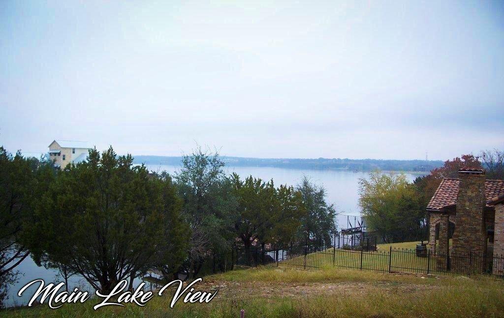 Beautiful lakefront building site with incredible views of the main body of Lake Granbury.  This lot has deep water and is on a natural inlet, in an area of the lake that is wide and open for fun and safe watersports! Properties along this street have sold for over a million dollars. Private boat docks are allowed with a permit from the Brazos River Authority. Located in the Canyon Creek subdivision which provides a community center, 24 hour guarded gate, swimming pools, tennis courts, parks, and boat ramps.  Granbury is a thriving community with a beautiful preserved historical square and has won USA today's Best Historic Small Town in America multiple times. Known for numerous events throughout the year and is is often called the Celebration Capital of Texas!  Perfect for your weekend getaway or living a full time vacation lifestyle!  Easy access to Fort Worth, DFW metroplex, DFW International Airport, State Parks, hiking, and biking.  Canyon Creek is a guard gated community and a valid driver's license is required for entrance.
