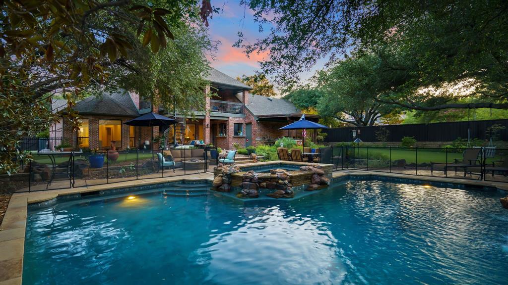 This luxury estate in Plano's exclusive White Rock Creek Estates offers a blend of traditional charm with a modern twist. Soaring entry with contemporary fixtures combines timeless elegance and today's functionality. 5 bedrooms and a study ensure space for everyone and the additional full bath down makes this floorplan perfect for multigenerational living. Chef's kitchen with gas cooktop, sub-zero refrigerator, double ovens, butler's pantry, and tons of storage make entertaining easy. The open floorplan flows into the family area with a wall of windows overlooking your amazing backyard.  Exquisite primary and ensuite provide the peace and tranquility you would expect in a luxury home. Upstairs boasts 4 beds, 2 full baths, large playroom, and a balcony overlooking the backyard. Contemporary pool with hot tub, waterfall, outdoor kitchen, lounging area, fire pit, dog run, lots of grass, and even a putting green! The porte cochere is just right for shooting hoops or an extra party space.