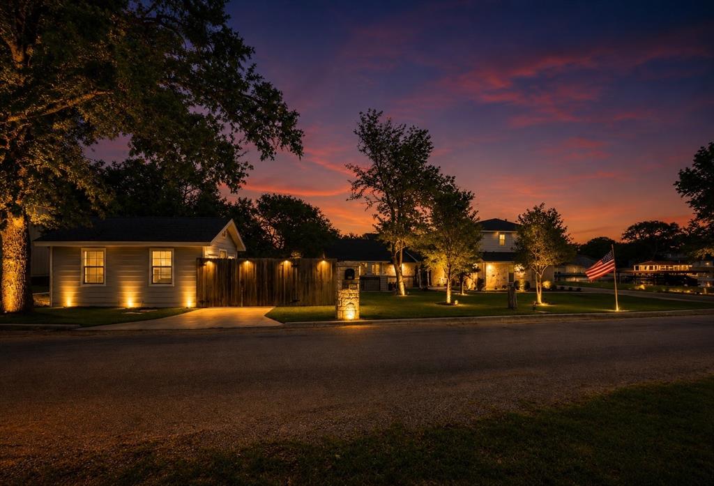 Embrace  the allure of lakeside luxury and immerse yourself in the finest waterfront living experience.

Discover the perfect fusion of luxury, comfort, and a vibrant waterfront lifestyle at this remarkable lakefront residence, situated in one of Granbury’s most coveted waterfront communities. Nestled in a tranquil area with direct access to the main body of Lake Granbury, this exquisitely designed home boasts breathtaking water views, expansive outdoor living areas, and effortless indoor-outdoor entertaining opportunities.

From the moment you arrive, you will be captivated by the meticulous attention to detail, inviting curb appeal, and peaceful waterfront ambiance. Inside, the home showcases an open-concept floor plan that maximizes natural light and stunning water vistas. Spacious living area seamlessly connects to the gourmet kitchen and dining spaces, creating an ideal setting for both everyday living and entertaining.

Step outside to your private waterfront oasis, where a generous deck, covered patio, and multiple seating areas provide the perfect backdrop for enjoying morning coffee, sunset cocktails, and lakeside gatherings. With a private boat ramp, two boat lifts, a jet ski lift, and separate concierge quarters, all surrounded by mature landscaping and serene views, this home offers a resort-style atmosphere year-round.

Whether you are seeking a full-time residence, a weekend retreat, or a lucrative investment opportunity, this property embodies the ultimate Lake Granbury lifestyle, with boating, fishing, watersports, and the charming historic downtown Granbury just minutes away.

**PROPERTY HIGHLIGHTS
* Prime waterfront 
* Expansive waterfront outdoor living 
* Abundant natural light with captivating water views
* Minutes away from Historic Downtown Granbury 
* Perfect as a primary, vacation home, or investment property
* Furnishings are negotiable