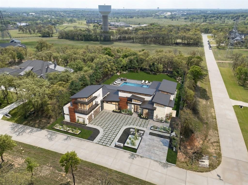 Set on a secluded 2-acre corner lot in sought-after Hat Creek Estates, this exceptional new construction in Bartonville offers the perfect blend of privacy, design, and modern luxury.  Surrounded by mature trees and located within highly regarded Argyle ISD, the setting alone is hard to replicate. Thoughtfully designed by Oscar E. Flores Design Studio, this single-level home showcases elevated architecture paired with carefully curated, high-end selections throughout.  Every detail has been intentionally considered - from the flow of the floorplan to the finishes that define each space. The expansive layout is designed for both everyday living and effortless entertaining, featuring open-concept living areas, a chef-inspired kitchen, and seamless indoor-outdoor connectivity. Generous windows invite natural light while framing views of the surrounding trees, enhancing the sense of privacy and tranquility. This is a rare opportunity to own a fully custom, design-forward home in one of Bartonville’s most desirable communities.  Additional features and finish details are available in MLS or upon request.
