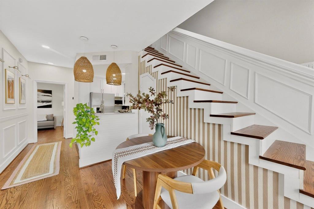 Top-floor condo in the heart of Oak Lawn offering a highly flexible layout with dual primaries, amazing natural light, TONS of thoughtful updates & a lower HOA! The current owners have spent the last year totally transforming this space and are only moving due to a job relocation. Major updates (2025) include new hardwood floors (replacing all laminate & carpet), fully repainted interior, gallery wall & staircase wainscoting, Google Nest & refreshed upstairs primary bath. Gorgeous living room features a wood-burning fireplace with an updated hearth and opens to a charming private balcony. Kitchen is equipped with sturdy quartz counters (+built-in cutting board countertop!), a farm sink & upgraded pendant lighting. Downstairs bedroom is perfect as private office space, second living room or as a second primary, complete with an ensuite bath & large walk-in closet. Stunning primary bedroom upstairs featuring a window seat, vaulted ceilings & a massive walk-in closet. Full bath remodeled with new Beadboard paneling & vanity mirrors, plus a second walk-in closet. So much storage throughout! The unit also comes with assigned garage space (+a new garage remote) for enclosed parking, with security gates & private entry to the complex. Located in a fantastic area walking distance to Eatzi's, La La Land & the Katy Trail, minutes to scenic Turtle Creek parks & trails, Oak Lawn night life & everything else Uptown Dallas has to offer!