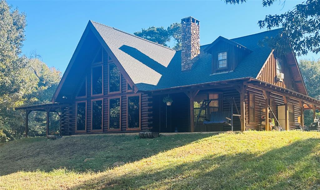 Nestled in the heart of nature, this stunning two-story log home offers the perfect blend of rustic elegance and modern comfort. With 4 spacious bedrooms and 3 bathrooms, this home provides ample space for both family living and entertaining.  The picturesque property is surrounded by mature trees, offering both privacy and a serene atmosphere. A sparkling swimming pool beckons on warm days, while a nearby pond adds to the peaceful setting, attracting local wildlife such as deer, making this property a nature lover's dream.  The property also features a large shop, ideal for hobbies or extra storage, and boasts a beautiful, welcoming entry that sets the tone for the entire estate. Whether you're enjoying the great outdoors or relaxing in the cozy interior, this home offers a true escape from the hustle and bustle of daily life.