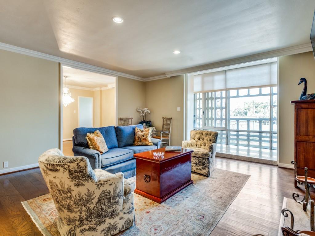 Discover timeless elegance in this iconic Turtle Creek residence, designed by Howard Meyer and listed on the National Registry of Historic Places. Enter through custom doors into a private foyer, setting the tone for this sophisticated home.

The living and dining areas feature wood floors, an electric fireplace, and floor-to-ceiling windows, with a full-length sunroom creating a versatile retreat. The kitchen honors its mid-century roots with original metal cabinets, paired with a Dacor stainless steel oven, induction cooktop, and stainless steel refrigerator.

The primary suite offers an en-suite bath and cedar closet, while the second bedroom features built-ins overlooking the oval pool and a stunning magnolia tree. Both bathrooms are fully remodeled with modern finishes. Additional highlights include built-in bookshelves, private basement storage, and two assigned garage parking spaces.

The building's iconic brise soleil filters the Texas sun with mid-century charm. Residents enjoy 24-hour valet and concierge service, a guest suite, fitness center, conference room, and the legendary Turtle Room with catering kitchen. The shaded oval pool and outdoor grill patio complete this resort-style lifestyle.

Minutes from Katy Trail, Kalita Humphries Theatre, and the dining and shopping of Uptown, Oak Lawn, Knox District, Arts District — this is lock-and-leave luxury at its finest.

HOA covers all utilities including internet; building amenities are plentiful, including 24-hour concierge and valet, fully furnished guest suite, pool, gym and club room with full catering kitchen.