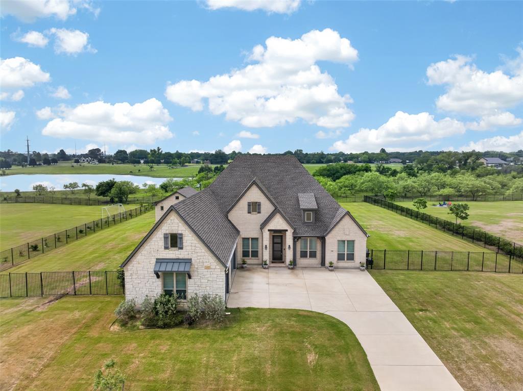Located in desirable Spring Lake Estates and zoned to Sunnyvale ISD, this beautifully maintained 1-story home sits on approximately 1.197 acres and offers a backyard designed for both everyday enjoyment and entertaining.The backyard features a heated saltwater gunite pool with spa, waterfall, and an approximate 500 sq ft pool house with full bath, custom cabinetry, accent lighting at the TV feature wall, and a separate enclosed area for pool equipment. With no neighbors behind due to the natural area, the lot offers a peaceful and private backdrop. Inside, large windows overlook the beautiful property and fill the home with natural light. This 4-bedroom, 3-bath home offers approximately 2,983 sq ft, wood flooring, split bedrooms, a dedicated office, flex room with barn doors, dog room with barn door, custom kitchen bar, and a spacious open layout. The living room features a stacked stone gas fireplace, while the kitchen includes granite countertops, built-in cabinetry, double ovens, gas cooktop, walk-in pantry, and breakfast area. The primary suite offers a soaking tub, oversized shower, vanity area, and walk-in closet. Additional highlights include custom garage cabinetry with 2 TV inserts, attic flooring, EV charging station, full fencing added in 2020, JellyFish exterior lighting, and roof replaced in 2025 with warranty.
