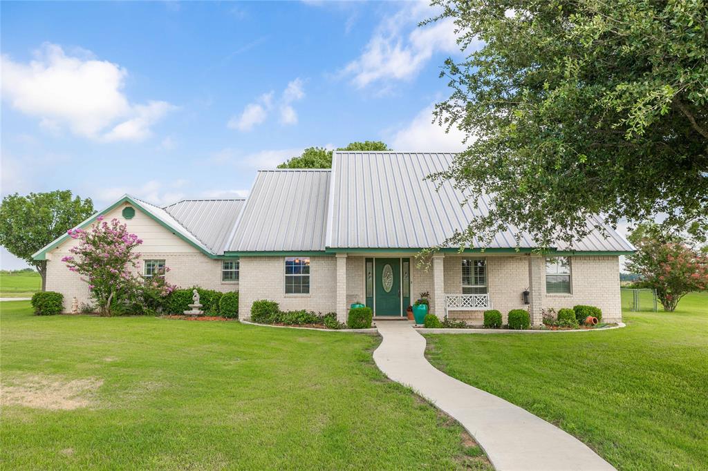 NEW PRICE IMPROVEMENT! Set back for privacy this Elegant 2709 square foot home has 3 bedrooms. 2 full bathrooms and a half bath. Let's talk about entertaining! Beautiful high ceilings with crown molding in this grand living room with a wood burning stove for that cozy feel. PLANTATION SHUTTERS THROUGHOUT!  The private dining room is ideal for family and friends at the holidays. There is enough room in the kitchen for everyone to help with the holiday baking. The breakfast nook and bar with bar stools provide extra sitting. The bedrooms have custom closets. The primary ensuite has a soaker tub, spacious walk in shower, separate vanities and his and her closets! A private office for working from home. The entrance to this Beautiful home leads you through lush grass and beautiful trees to double covered parking. The backyard is cross fenced which is perfect for children and pets. Enjoy the sunrise from your front covered porch and take in the sunset from your large covered back porch. There is a well that is run by a wind mill which feeds the pond. Bring your horses and FFA projects. This Beautiful home has been lovingly taken care of. Hurry and make this your forever home!  Call today and not miss the chance to own this rare beauty!!