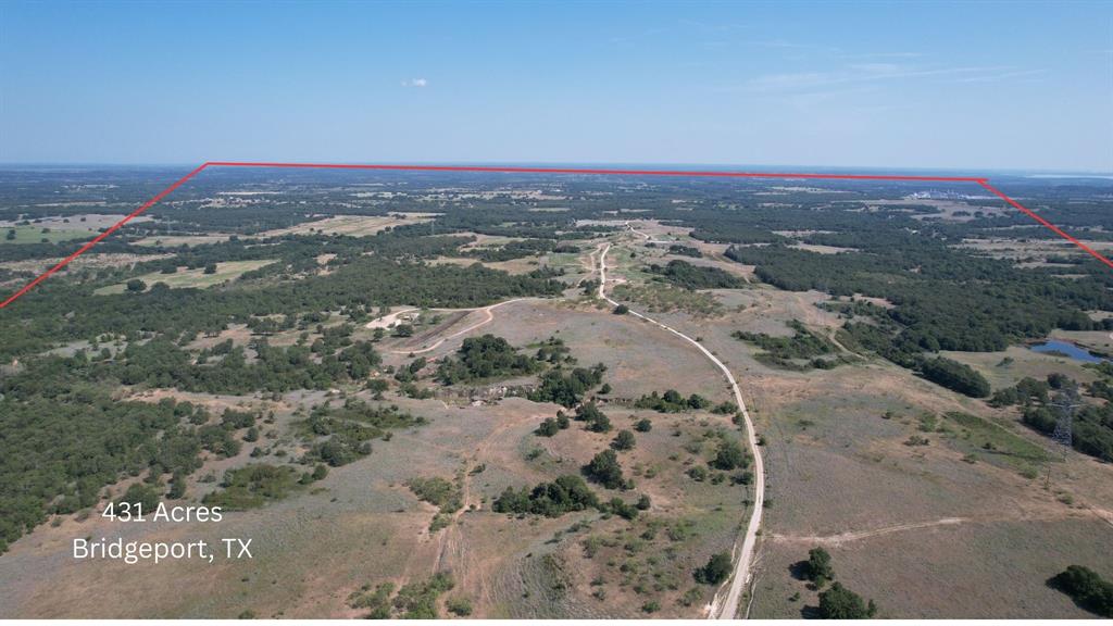 Welcome to the breathtaking 431-acre Holden Ranch, a property that captures the essence of Texas ranchland with sweeping vistas in every direction. This ranch offers incredible diversity with mature hardwoods, dramatic elevation changes along a ridge running north to south, fertile bottomland, and a live creek on the west boundary. Whether you are seeking a recreational retreat, working ranch, or long-term investment, Holden Ranch delivers it all.

The property is improved with electricity throughout most of the acreage and a water well near the deer camp on the north side. Water resources are exceptional with six large stock tanks—three in the north and three more in the east and south pastures—providing ample water for cattle, wildlife, and overall land management. The ranch also sits above a productive aquifer, a natural underground reservoir that offers reliable, sustainable water. Beyond supporting ranching and recreational use, the aquifer adds investment value, as companies often lease water rights for municipal, industrial, or ag purposes. This creates an opportunity for an additional revenue stream while preserving the property’s ag and recreational uses.

Large neighboring ranches to the west and east enhance seclusion, ensuring peace and privacy, while careful stewardship has cultivated abundant wildlife and excellent hunting. The property is Ag Exempt and located less than an hour from Fort Worth, offering both convenience and seclusion. Additional features include two access easements—one serving a small gas plant on the southern boundary and another from an adjoining landowner to the east—plus two pipeline easements on the south and east sides. Minerals are surface only, and mineral rights do not convey; one producing well on site.

This extraordinary ranch combines natural beauty, privacy, and utility with long-term income potential, making it a rare opportunity for ranching, recreation, or investment.