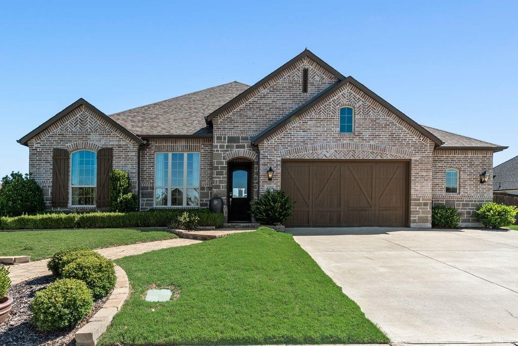 **Pristine Elegance in Rockwall County**

Discover the epitome of luxurious living in this stunning 4-bedroom, 3.5-bathroom Former Highland Homes Model with Tons of upgrades in an Oversized lot  nestled in the heart of McLendon-Chisholm, Texas. Situated on an expansive lot, this property boasts a beautifully crafted brick and stone elevation, offering enchanting curb appeal from every angle. The meticulously designed home is complemented by a spacious 3-car garage and exquisite landscaping.

Step inside to a world of refinement with an open-concept layout that seamlessly blends elegance with functionality. The interior is graced with soaring high ceilings that enhance the sense of space and light, making it ideal for both intimate gatherings and grand entertaining. The expansive living area flows into a breathtaking kitchen where culinary dreams come to life. Abundant cabinetry provides ample storage, while a strikingly large kitchen island serves as the perfect centerpiece for meal preparations and casual seating.

Indulge in ultimate relaxation within the primary suite, featuring a luxurious tub and shower combo, designed for your personal sanctuary. This home offers three additional well-appointed bedrooms, each promising comfort and style, along with a dedicated guest suite ensuring privacy for visitors.

Outdoor living is effortlessly elevated with a generously sized covered patio, ideal for alfresco dining and enjoying serene Texas sunsets. The oversized lot provides ample space for outdoor activities or future customizations, all enveloped in elaborate landscaping that creates a private oasis.

This  gem combines modern amenities with timeless design, presenting an unparalleled opportunity to own a piece of North Texas tranquility. Make this residence your haven today.