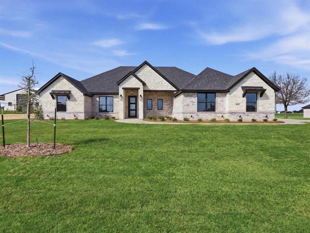 Brand new Al Couto Homes custom-built in Weatherford’s Elevation Estates, offering the space, layout, and upgrades designed for modern Texas living. Situated on a full 1-acre lot, this new construction home features an open-concept floor plan ideal for both entertaining and everyday life. The spacious living room welcomes you with soaring ceilings, coffered ceiling detail, abundant natural light, and a dramatic floor-to-ceiling fireplace. The chef’s kitchen anchors the home with a stunning quartz waterfall island, custom stained cabinetry, quartz countertops, stainless steel appliances, and a large walk-in pantry designed for both function and storage. The private primary suite offers a spa-inspired retreat with a freestanding soaking tub, oversized walk-in shower, dual vanities, and a large walk-in closet with built-in shelving. Secondary bedrooms are generously sized and thoughtfully arranged in a split-bedroom layout for added privacy for family or guests. Additional features include a dedicated home office, spacious laundry room with storage, wood-look tile flooring, crown molding, spray foam insulation, and quality craftsmanship throughout. Step outside to the covered back patio overlooking the expansive backyard, offering endless potential for a pool, shop, outdoor kitchen, or future workshop. Located in one of Weatherford’s growing acreage communities, residents enjoy no HOA, no PID, no MUD, and low property taxes while still being a short drive to shopping, dining, and major highways.