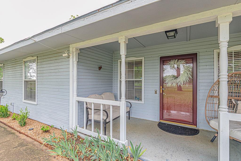 Welcome to 8397 County Road 2580, a beautifully updated ranch style retreat set on 1.32 peaceful acres in Royse City. This 2508 square foot home blends modern comfort with timeless charm and offers three spacious bedrooms and three full bathrooms in an open and thoughtful layout. Two large living areas provide room to relax and gather, and the decorative wood burning fireplace adds a cozy touch. The kitchen is a true highlight with granite countertops, penny tile backsplash, a farm sink, stainless steel appliances, a large walk in pantry, and a generous dining area that works well for everyday meals or entertaining. The oversized primary suite feels like a private getaway with a sitting area, dual vanities, a walk in shower, and an expansive walk in closet. Two additional bedrooms offer great space and storage, including one with its own private ensuite that is perfect for guests or multi generational living. A third full bath and a second large living area add even more flexibility for work, play, or quiet time. Step outside and enjoy true country living. The covered patio, fire pit, and wide open backyard surrounded by mature trees create a relaxing outdoor setting. The oversized 30 by 26 detached garage includes a workshop and extra storage for hobbies or projects. The impressive 20 by 50 red barn features an attached carport, three stalls, a tack room, and a versatile flex space with AC that can be used for animals, creative work, or additional storage. 
Located outside city limits with no HOA and zoned to Royse City ISD, this property offers space, freedom, and a peaceful lifestyle while still being just minutes from town.