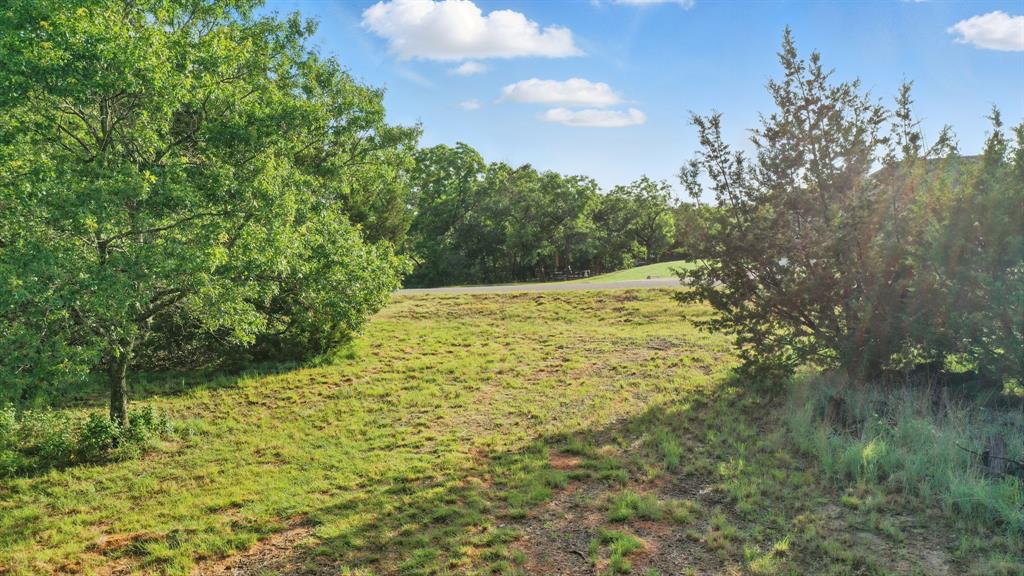 Discover the perfect canvas for your dream home on one of the last lots available in the serene SaddleCrest subdivision, nestled in the highly sought-after North Weatherford area. This 2.279 acre lot offers a picturesque setting with winding roads and slightly rolling terrain, with a large stocked tank in the rear of the lot. Enjoy the freedom of no HOA, while adhering to deed restrictions that protect your investment and enhance your country living experience. Choose your own builder and create a residence with ample space and privacy, including a guest house and room for your horses. Embrace country living with the added benefits of no city taxes and the potential to install a private well for no water bill. Plus, high-speed AT&T Fiber. Nearby amenities make this an ideal location for your dream home. With appropriate masonry, brick, and siding requirements met, a steel framed home known as a barndominium may be constructed.