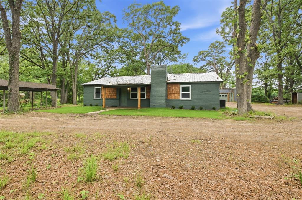 Charming home in the country sitting on 5.53 acres five minutes from the acclaimed new Bois d Arc lake - about an hour northeast of the DFW area.  Nestled in the trees, this updated three-bedroom, two bath home features an open living, kitchen, and dining area and has the FEEL of a cozy mountain cabin.  Enjoy the new kitchen with lots of storage and counter space, including a large island and new appliances - refrigerator, dishwasher, microwave, and stove.  Both bathrooms have been remodeled.  Large laundry area with abundant storage just off the kitchen.  Primary suite is separated from the other two bedrooms.  Fresh paint inside and out.  

Relax on either the front or back covered porch or fish in the pond at the back of the property.  Lots of options with this property - a quaint family home, a perfect weekend getaway given its close proximity to Dallas, or ideal for someone who wants to have a mini-farm.   

The property has several outbuildings including a 30' x 16' shop with electricity, a two-story shed 22' x 12' with electricity and an AC unit, another small outbuilding for storing lawn equipment, and a separate carport.  If you are looking for a country retreat, you owe it to yourself to look at this one!  OWNER FINANCE AVAILABLE!!!!!