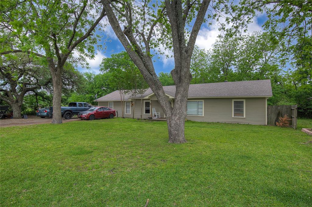 Welcome to this beautifully updated home in the heart of Wills Point, perfectly positioned for an easy commute to both Dallas and Tyler. Remodeled in 2018, this property blends timeless charm with modern functionality, creating a warm and inviting space you’ll love coming home to. Step inside to an open-concept layout where the kitchen, dining, and living areas flow seamlessly together—ideal for both everyday living and entertaining. The kitchen features stunning American oak butcher block countertops, abundant cabinetry, and a layout that keeps you connected to the heart of the home. The spacious primary suite offers a private retreat with his-and-her walk-in closets, while the additional bedrooms are thoughtfully designed with a Jack-and-Jill layout and rich mahogany bamboo flooring that adds both style and durability. Beyond the interior, enjoy a large lot shaded by mature trees and a newer deck—perfect for grilling, relaxing, or gathering with friends and family. With flexible living space that can serve as an office or second living area, this home adapts easily to your needs. Located just minutes from downtown Wills Point, you’ll appreciate the small-town charm with convenient access to major commuting routes. This is a home that offers space, character, and location—all in one. Come see it for yourself.