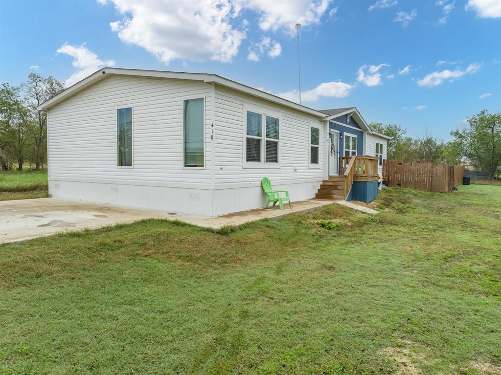 2021 Model!  Perfect blend of modern comfort and convenience in this barely lived in mobile home centrally located between DFW & Waco. With 3 bedrooms, 2 baths, and a flexible formal dining area that could serve as a 4th bedroom, this home caters to your evolving needs.  The farmhouse sink with bright windows and modern cabinets highlight the stylish kitchen, while 2 living areas provide ample space for relaxation and entertaining.  Secluded Master bedroom suite that connects directly to the laundry area and each full bath has double sinks!  Enjoy the outdoors in the privacy fenced backyard! Come see this affordable home with space for everyone all in your budget!