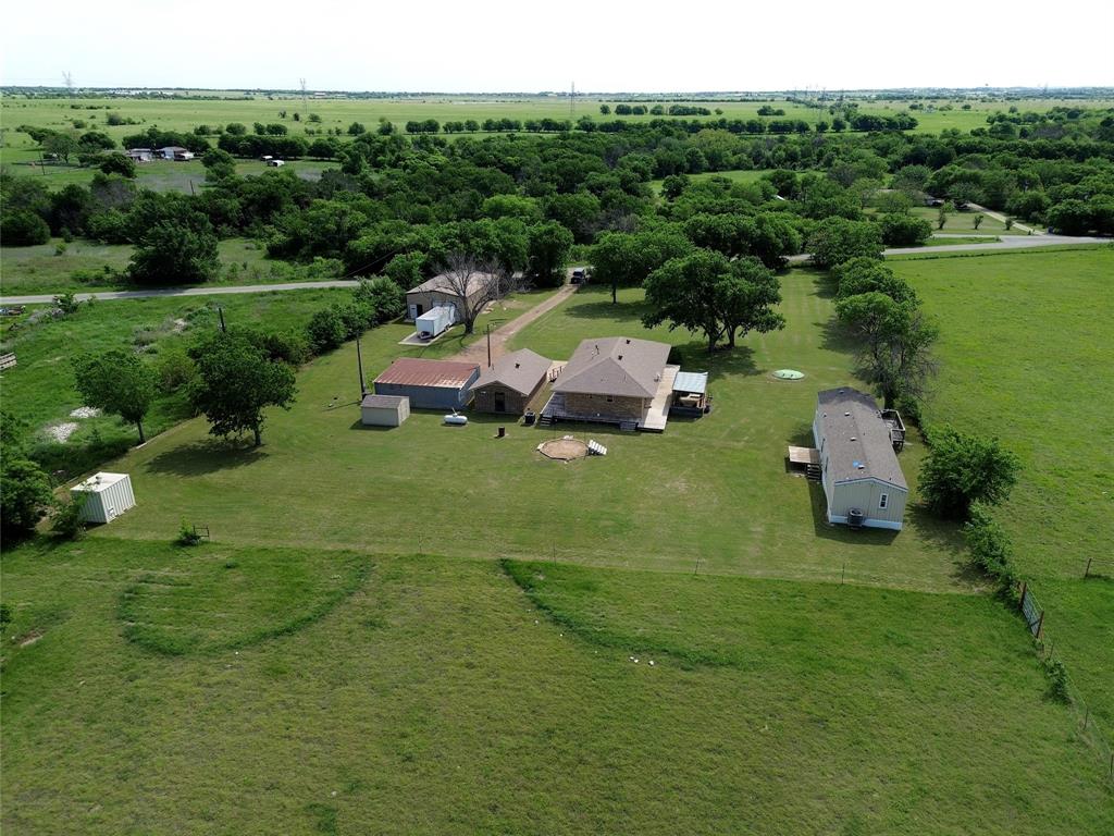 Welcome to your dream country property!! A solar powered gate opens up to a little over 5 acres with two homes for your family.  The main home(house#1) has a deck all the way around the outside, so you can choose where to sit to drink your morning coffe or watch the sunset in the evening.  Two bedrooms both have ensuite bathrooms. Eat-in kithen is perfect for a little bistro table in front of the picture window. Gas cooktop and oven are a hit with the gourmet cook in this kitchen. Custom glass paneled cabinet doors add a marvelous touch the well appointed cooking area. Don't forget the mother-in-law suite that sets directly beside the home(house #1).  ADU's are trending now with generational families living together.  The sky is the limit! ADU is plumbed and has electricity and is just waiting to be finished out to your style. In ground storm shelter is between the two houses. House #2 has two bedrooms and two full bathrooms. The living and kitchen areas blend together for a fantastic entertaining environment.  A 30'x50'x12' shop with cement floor, electricity and two roll up doors, is the cherry on top of this property. Go ahead and bring your animals, there is room for all of them on the back acreage. So many fabulous things to tell about this country property. It is the package deal for country living. Go ahead and schedule your showing now.
*Go to the virtual tour to see a floorplan of House #1 and a walking tour of both homes.
First American Home Warranty currently in place on this home.
