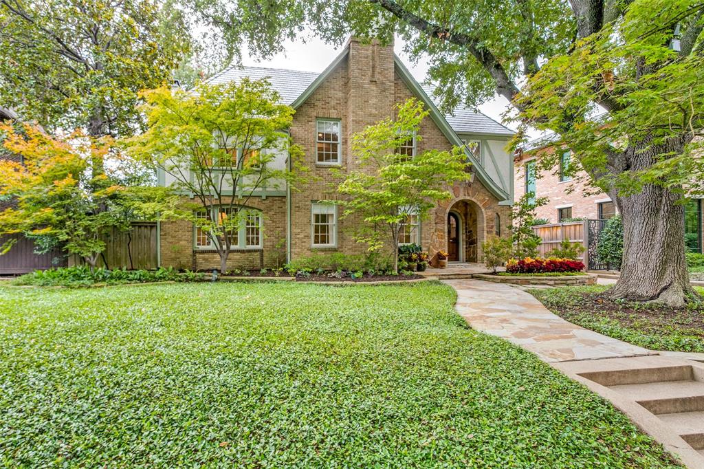 Stunning historic Tudor residence designed by architect Clyde Griesenbeck. Updated living spaces with hardwood floors and tall ceilings maintain their original charm and character. Designer finishes throughout. Living room with stone fireplace. Dining room with built-ins. Open concept kitchen and family room includes a brick fireplace surrounded by custom shelving and a breakfast nook. The renovated kitchen features custom cabinetry, marble countertops, Lacanche range, built-in Sub Zero and more. Cozy den with barrel vaulted ceiling, stone fireplace and steel French doors to patio. Primary suite with sitting area, large walk-in closet and updated bath with marble countertops, walk-in shower and freestanding tub. Two spacious secondary bedrooms with private baths. The third level includes the 4th bedroom, a full bath, study area and laundry room. Situated on an oversized lot with majestic trees. Backyard with turfed yard, outdoor kitchen and fire pit. Two car garage with guest quarters.