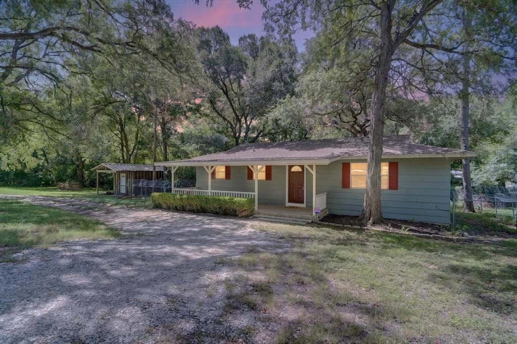 Charming 2-bedroom, 1-bath home offering approximately 1,000 square feet of comfortable living space. The generous living area flows into a the dining area and spacious kitchen featuring abundant cabinet space and extra storage. The current owner has updated the home with attractive new flooring, adding a fresh, inviting feel. Situated on an expansive 0.908-acre lot, this property provides plenty of room to enjoy the outdoors. Mature trees create a beautiful setting, while the covered porch offers a relaxing place to unwind. A workshop with electricity and a separate storage shed provide excellent space for hobbies, projects, or additional storage.The property backs to a creek and is conveniently located near Lake Granbury access and a nearby boat ramp, making it easy to enjoy fishing, boating, and other outdoor recreation.Whether you’re looking for a full-time residence, weekend getaway, or investment opportunity, this property offers a unique combination of indoor comfort and outdoor space. Schedule your showing today and come see everything this property has to offer!