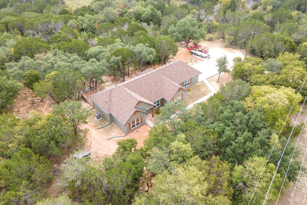 GORGEOUS LIKE NEW HOME ON 5 SECLUDED ACRES! You will love the privacy of this pristine, immaculate home, shielded from the road by a wall of trees! Beautiful open floor plan with spilt bedrooms! Open kitchen with eye catching granite, undercounter lighting, and stainless appliances, flowing into a large, spacious living area for the family! Home features luxury vinyl plank flooring, spray foam insulation, and large utility room! Large master suite with large shower, and separate closets! Oversized fabulous back deck hidden from view! Some trees could be cleared to open up the view if desired. Whole house surge protector and an 18' garage door! Hot tub is negotiable.