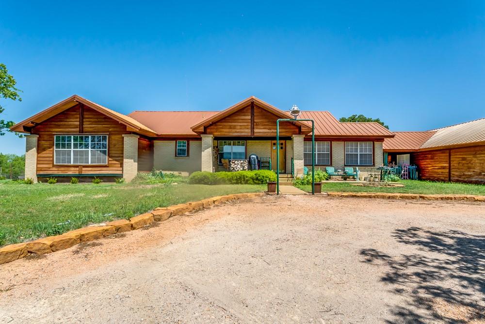 The property at 110 CR 567 in Eastland is situated on six acres of land, at Lake Leon. This property is an ideal retreat for anyone looking to escape. The main house features 3 bedrooms and 2 bathrooms, providing ample space for a family or for entertaining guests. The floor plan offers plenty of natural light and a spacious feel. The property also includes an 800-foot guest house, complete with a living space, a full bath and kitchenette, perfect for a private retreat for guests. All appliances included. One of the best features of this property is its proximity to the community dock, which is just a short walk away. This dock provides access to Lake Leon, where residents can enjoy fishing, swimming, and there is a boat ramp. The property also features an underground cellar located between the main house and guest house, perfect for use as a storm shelter or for additional storage space. The 1200 ft over-sized garage fits 4 vehicles, providing plenty of space to park the toys.