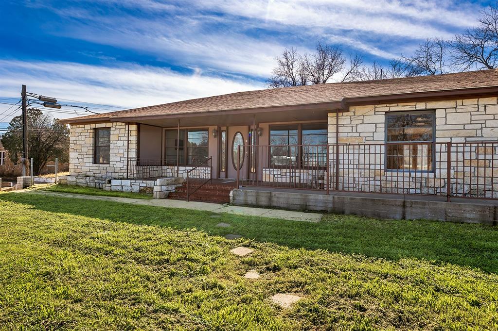 PRIME location with a paved parking lot, this Austin stone building is ready for a fresh, new vision. Nearly 4,000 square feet of potential on 0.46 acres with Hwy 377 S Bridge St. frontage. Zoned COMMERCIAL, This property offers excellent bed and breakfast or multi-family. scenarios with eight private rooms, and six bathrooms with multiple set ups including: two full private baths, three Jack and Jill baths, and a half bath in main living foyer space. This property also includes a full working kitchen with gas range, dishwasher and a large peninsula. To the south of the main building there's a separate, 860 square foot studio type apartment with full bath as well. 
This property offers great, investment opportunity, potential multi-family options - bring your ideas and call for a showing! 325-792-8345