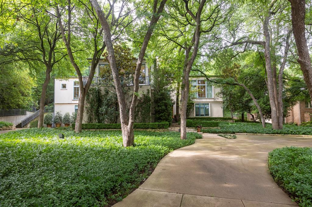 Rare opportunity to be close to Colonial Country Club and TCU in this secluded yet convenient heavily wooded property offering serene privacy. Custom built and architecturally designed by the current owner this sophisticated and timeless masterpiece showcases high quality finishes and attention to detail. Floor to ceiling windows allow breathtaking views of the private surrounding grounds and allow abundant natural light. One living area with a fireplace opens to a balcony to further enjoy the private surroundings. The expansive kitchen with a Thermador gas cooktop, double oven, warming drawer, built-in Subzero refrigerator, icemaker allows for a dining area and comfortable sitting area. Another living area features a fireplace , wet bar and views of the back of the property. The primary suite is a retreat along with three other bedrooms allowing for multiple living arrangements. The combination of privacy yet relatively ease of upkeep make this truly desirable and hard to find!