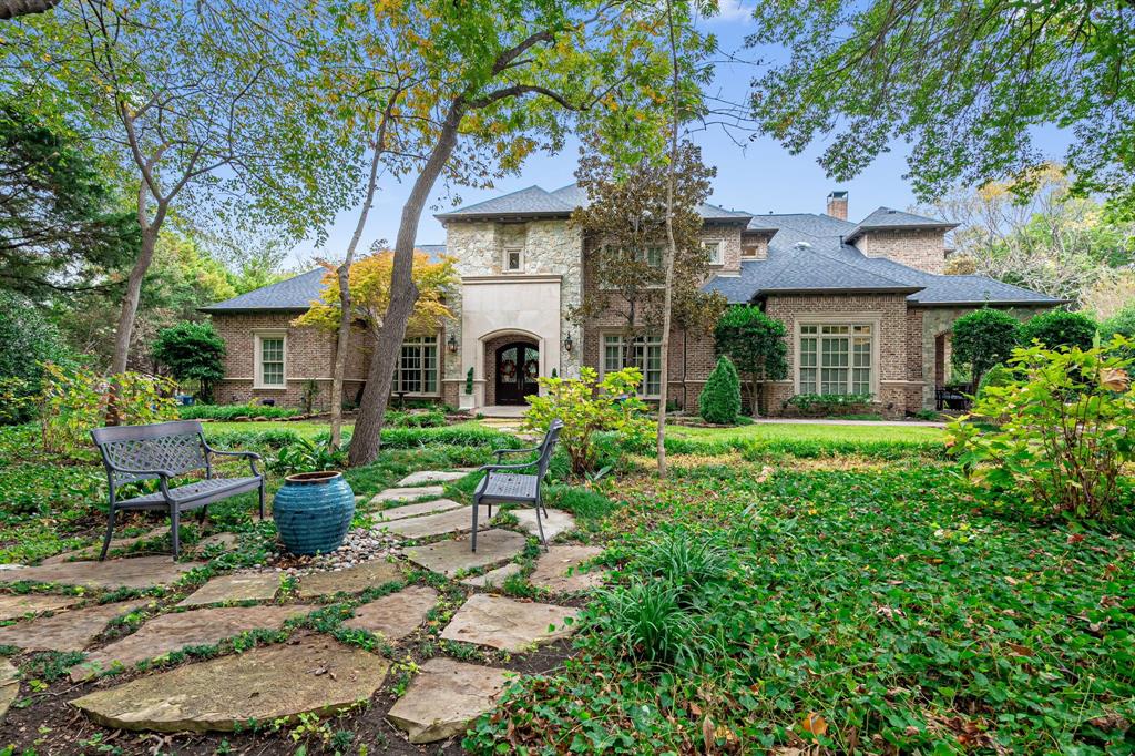 Luxurious Custom Estate on Wooded Creek Lot Nestled on a breathtaking 1.3-acre wooded lot with a serene creek, this exquisite custom home offers a private retreat with unparalleled craftsmanship and luxurious details throughout. Meandering stone paths lead to tranquil seating areas, creating an outdoor sanctuary like no other. Inside, stunning millwork, designer lighting, and refined finishes elevate every space. The main level seamlessly blends indoor and outdoor living, with formal rooms opening to an expansive outdoor oasis. A hidden door connects the sophisticated study to the primary suite, where a marble fireplace and spa-like bath with a walk-through double shower, heated towel bars, and a private exercise room redefine luxury. A first-floor guest suite ensures a warm welcome. The heart of the home is a bright, open kitchen with endless counter space, an oversized pantry, and a prep sink for effortless entertaining. The adjacent breakfast nook, framed by a wall of windows, overlooks the creek and opens to a covered patio—perfect for morning coffee or alfresco dining. The inviting family room, anchored by a gas fireplace, provides seamless access to the sparkling lagoon pool, outdoor kitchen, and fire pit, all set within a beautifully landscaped, private backyard. Upstairs, a media room, game room, and craft room offer endless entertainment, while three spacious bedrooms—two with bonus areas—provide flexibility and comfort. With two staircases for easy flow, this home is designed for both grand entertaining and intimate gatherings. A rare blend of elegance and tranquility, this estate is a must-see. Lovejoy ISD! Recent updates include a new roof (2023), water heaters (2022), remodeled bathrooms, three of four AC units replaced (2022), fresh interior paint & carpets, and updated kitchen countertops.