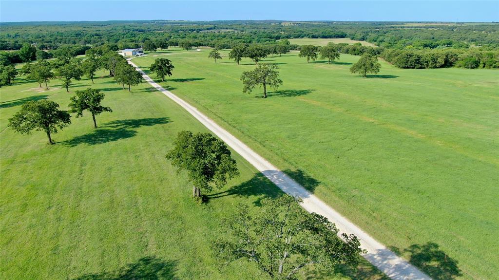 Welcome to Liberty Chapel Ranch — a productive and well-balanced 320 acre cattle and hay ranch located just north of Saint Jo, Texas in the heart of beautiful North Texas ranch country. This versatile property offers a strong combination of agricultural functionality, water resources, recreation, and comfortable country living.

The ranch features a well-maintained 3-bedroom, 2-bath manufactured home that provides a comfortable primary residence, weekend retreat, or ranch headquarters. Improvements include a 36x36 insulated shop with a 9x36 climate-controlled storage room, additional barn, and well-designed cattle working pens ready to support an active livestock operation.

The land is cross fenced into 6 separate pastures allowing for efficient rotational grazing and livestock management. Improved grasses and productive hay fields contributed approximately 220 bales of hay production last year, highlighting the ranch’s strong agricultural capabilities.

Water is abundant with 2 water wells, 7 ponds, along with .75 of a mile of scenic Cottonwood Creek running through the property, providing excellent water sources for livestock and wildlife alike. The creek corridor, native trees, and open pastureland create an attractive setting with excellent recreational appeal for hunting, fishing, horseback riding, or simply enjoying the outdoors.

Whether you are looking for a working cattle ranch, hay operation, recreational retreat, or long-term land investment, Liberty Chapel Ranch offers the infrastructure, water, and versatility rarely found in today’s market.