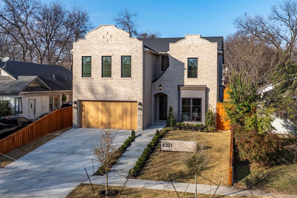 This 5-bedroom, 4,572-SF new construction home is just blocks from Lakewood Village and rich with personality. A striking entry leads into thoughtfully designed living spaces. Soaring 11-foot ceilings on both levels and Andersen windows throughout, fill the home with natural light. The living room is anchored by a beautiful arched built-in, blending traditional character with modern scale. The kitchen is both stunning and functional, featuring white oak cabinetry, Thermador appliances, and a gorgeous island with open shelving and fluted details topped in Superior Bianco quartzite—an on-trend design with timeless appeal. Sculptural pendant lighting adds warmth and architectural interest, while zellige tile above the slab backsplash brings texture and depth. A dedicated prep area and oversized pantry provide exceptional storage and everyday ease. A bold, green color-drenched office offers a moody yet inviting workspace. The primary suite is conveniently located downstairs with generous proportions and an abundance of natural light. The primary bath showcases Mikonos quartzite and zellige tile, creating a spa-like experience. A stunning floating quartzite vanity highlights the downstairs powder bath and delivers a memorable design moment for guests. Upstairs, the home excels in functionality with four additional ensuite bedrooms thoughtfully arranged for privacy, along with a spacious game room that flexes easily for play, media, or gathering. Each secondary ensuite is uniquely finished with marble, custom cabinetry, and hand-selected tile details. Outside, the backyard is generously sized with room to customize to suit your lifestyle. Unlike many new builds that feel like a blank white canvas, this residence blends traditional elements, superior build quality, and spaces intentionally designed for modern living.