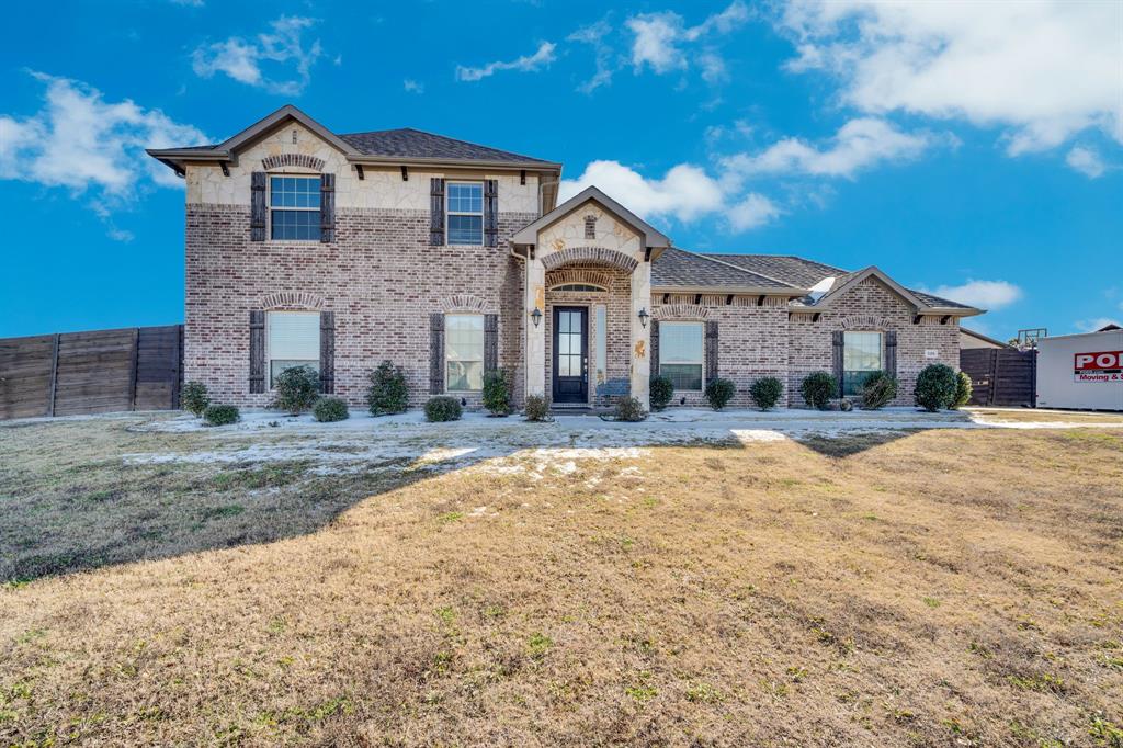 STUNNING 2,696 SF HOME ON 1 ACRE - NO CITY TAXES! Discover luxury living outside city limits while enjoying top-rated Waxahachie ISD! This exceptional property boasts soaring ceilings & an open-concept design perfect for modern lifestyles. The gourmet kitchen features white shaker cabinets, granite countertops, stainless appliances & a striking blue accent wall. Entertain effortlessly in the spacious living area showcasing a statement fireplace with custom shiplap surround, abundant natural light & seamless flow throughout. Premium finishes include wood-look tile flooring, elegant pendant lighting & contemporary railings. The generous 1-acre lot offers privacy, space for outdoor activities & future expansion possibilities. Experience small-town charm with big-city amenities - all while saving on city taxes! Schedule your private showing today!