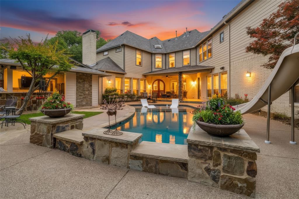 Set on a picturesque corner lot, this modern ranch-inspired residence is surrounded by mature trees, offering exceptional privacy & serene, tree-lined views from nearly every angle with an elevated yet comfortable lifestyle blending nature & refined design. Originally taken to the studs & reimagined in 2017, the home seamlessly merges timeless craftsmanship with modern luxury. Spanning nearly 4,900 square feet, it offers 5 bedrooms, 5.2 baths & multiple living areas designed for both effortless daily living & sophisticated entertaining. Inside, the open-concept layout features solid hardwood floors, abundant natural light & expansive views of the pool and lush grounds. The chef’s kitchen serves as the heart of the home, anchored by an oversized island and high-end custom finishes, flowing seamlessly into the dining area & dual living spaces. A striking oversized stone fireplace and custom built-ins create a warm yet sophisticated focal point. The backyard is a true private retreat, designed for year-round enjoyment with a stunning deep saltwater pool, a 5' firepit, covered patios, flagstone terraces & a fully equipped outdoor kitchen. The game room studio opens directly to this outdoor oasis, creating an ideal indoor-outdoor enjoyable atmosphere. A thoughtful layout includes a private main-level guest suite with a secondary living area, perfect for extended stays or multigenerational living. Upstairs, the spacious primary suite offers a serene retreat with a spa-inspired bath, dual vanities, soaking tub, dual-head shower, oversized walk-in closet & dedicated shoe cabinet. Two of three add'l bedrooms feature ensuite baths for added privacy. Ideally walkable to Lakewood Elem & Lakehill Prep schools, this exceptional property delivers a rare combination of space, privacy, craftsmanship & lifestyle - An estate where luxury, comfort & experiences come together perfectly