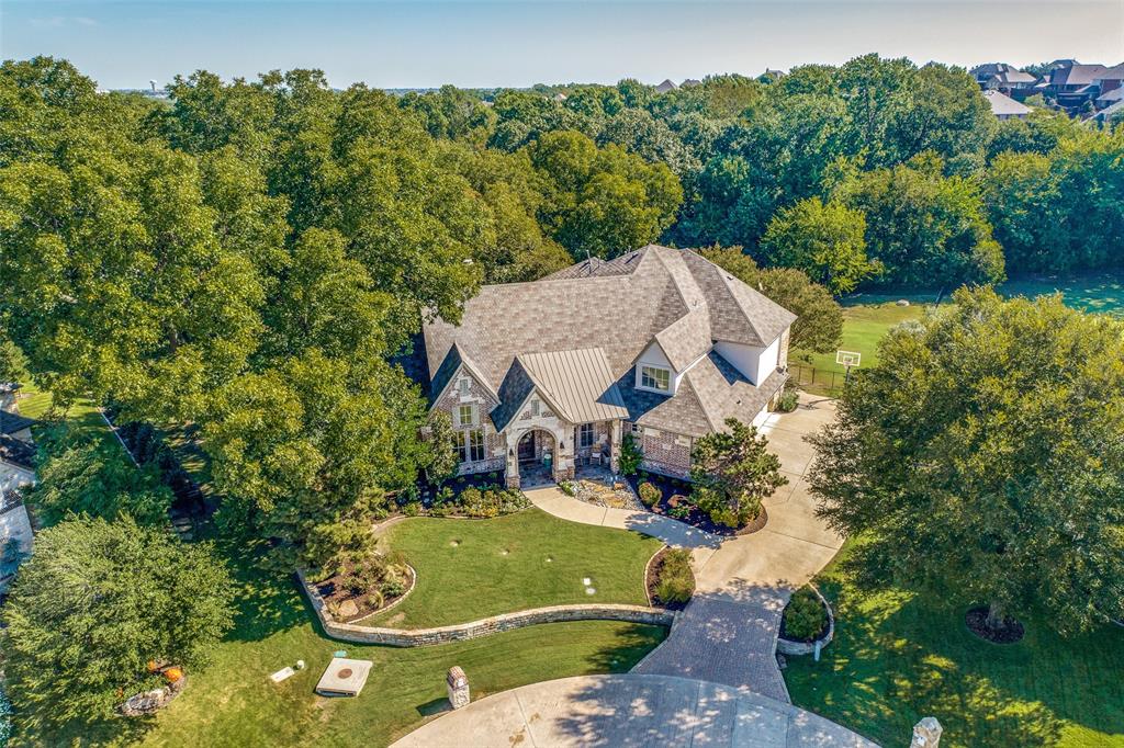 Gorgeous home in the sought after gated community of Stonebridge Estates. This 6 bed, 5 bath home is nestled on a 1.1 acre wooded cul-de-sac lot. Beautiful brick & stone exterior, lush landscaping, 4 car garage, elevator, backyard oasis with huge porch, pool & spa with 7 water features & large grassy areas. Beautiful arched front door welcomes you in. Hand scraped wood floors, tall ceilings, neutral paint & incredible millwork. Large living room with a wall of windows, built ins & fireplace. Kitchen is a chef's dream! Sub Zero built in fridge, Thermador appliances, wine fridge, decorative lighting, fireplace, built ins, coffee station, huge walk in pantry, massive island, open to the kitchen dining area with picturesque views to the backyard. This home is an entertainers dream! Large primary suite & guest room with ensuite down & four huge bedrooms all with ensuites & walk in closets up. Game room, media room & massive walkout attic, his & her offices, mud room & huge laundry room.