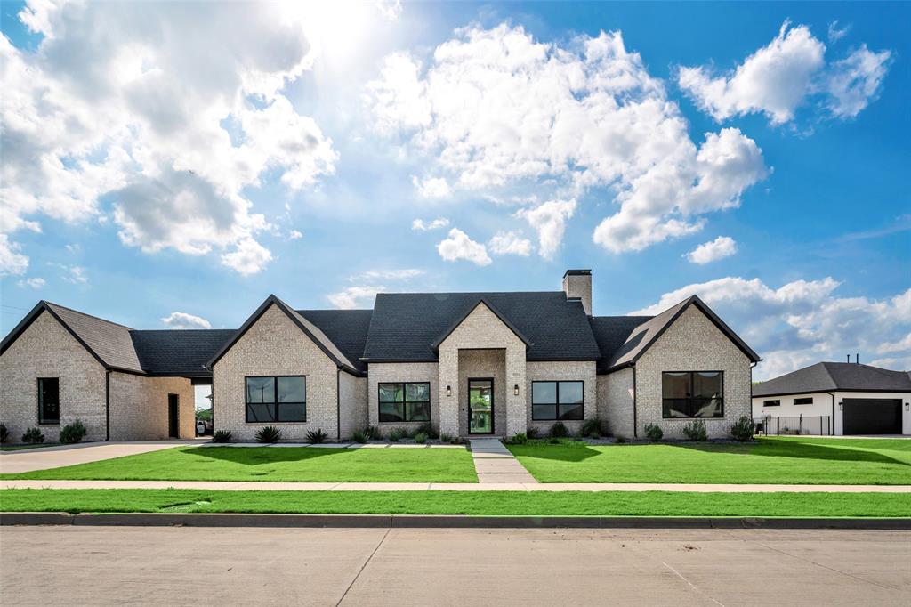 Refined single-story living awaits at 101 Ambrosia in Heath, Texas. This thoughtfully designed new construction home offers purposeful spaces wrapped in a peaceful, inviting setting—just a short walk to the beauty of Lake Ray Hubbard. Set on a generous lot, this modern home features four split bedrooms and an expansive great room where entertaining flows effortlessly into the heart of the home—the kitchen. Anchored by an impressive, oversized quartz island, an 8-burner gas range, and a large walk-in pantry, this space is designed for both everyday living and unforgettable gatherings. The secluded primary suite is a true retreat, offering a spa-inspired bath with dual vanities, a soaking tub, separate walk-in shower, and an oversized walk-in closet. Spacious secondary bedrooms provide flexibility for guests, a home office, or fitness space, while a second living area creates the perfect place for family and friends to gather. Step outside to the covered patio and take in the wide Texas sky. The expansive backyard invites you to design your dream outdoor escape—from a pool to custom living spaces—there’s room for it all. Complete with a 3-car garage, this 4 bed plus office home delivers both function and lifestyle. Located in the sought-after community of Heath, you’ll enjoy a rare blend of tranquility and convenience—just minutes from Dallas, yet steps from the lake, boat ramp, scenic parks, and walking trails. Spend your mornings bass fishing and your afternoons enjoying everything lake life has to offer, with dining and shopping just moments away. 101 Ambrosia is where country ease meets city access—a truly rare opportunity.