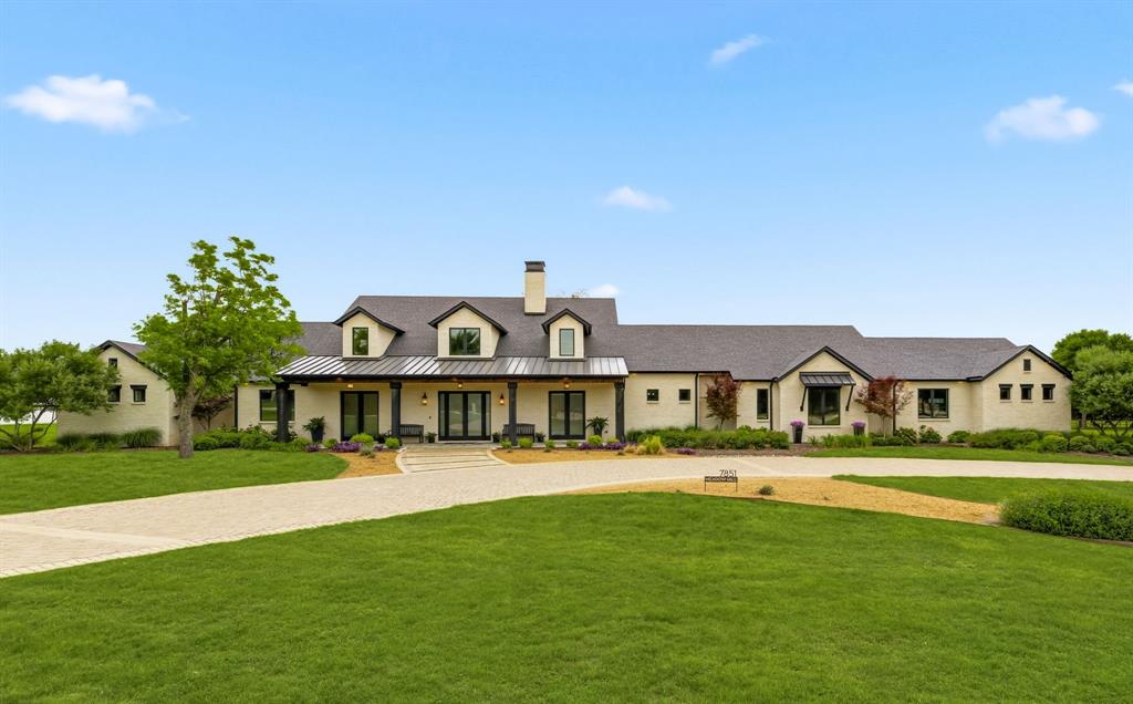 Rarely does a property emerge that truly defines the unicorn of real estate, yet this home does exactly that. Nestled on a nearly 5-acre, Ag-Exempt retreat with the rare freedom of NO HOA, this 6,343 sq. ft. custom masterpiece offers a lifestyle of quiet country soul just minutes from the high-octane energy of PGA Frisco, The Star, Toyota Stadium, and the Rail District. As you pass the circular drive, you enter a sanctuary defined by soaring vaulted ceilings and expansive windows framing views of the private pasture and resort-like backyard oasis. The heart of the home is a culinary theater: a chef’s kitchen featuring oversized dual islands with gorgeous quartzite countertops, stainless steel KitchenAid appliances, a dedicated beverage refrigerator, and antique mirrored cabinetry. An adjacent prep kitchen—complete with a third sink, second dishwasher, and walk-in pantry—ensures effortless hosting. The main level features a great room with a floor-to-ceiling stone fireplace and rich 8-inch hardwood baseboards. The primary wing is a true escape, featuring a brick accent wall, vaulted ceilings, a wall of windows overlooking the outdoor oasis, and a spa-like bath with a rain shower and soaking tub. The massive custom primary closet offers stylish storage options. Versatility defines the 1.5-story layout, featuring a downstairs media room and a custom pet spa with a built-in kennel and dog door. Upstairs serves as a perfect guest or mother-in-law suite with its own living area and full bath that easily converts into a versatile game room.  Outside, discover the resort-style grounds featuring a shimmering pool and spa and an elite outdoor kitchen equipped with a built-in grill, fridge, and sink, plus a cozy fireplace. Complete with an oversized 5-car epoxy garage, solid core doors, electronic blinds, and the rare benefit of city water paired with a private well for irrigation, this estate is a legacy property where Frisco luxury meets the peace of the countryside.