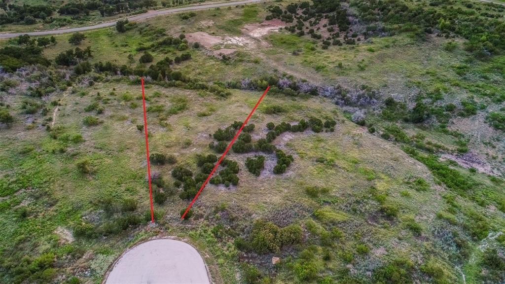 This beautiful two acre lot, located at the end of a cul-de-sac on one of the more elevated streets in The Hills Above PK, offers awe-inspiring view of gorgeous PK lake.  Situated with a slight uphill terrain, you can truly see natures artwork for miles.  A variety of native trees and flora mark the spot for the lake home of your dreams.  There is no time required for starting to build, so until you're ready, you can enjoy the land in its natural state and still have access to the many amenities available to HAPK property owners.  The gated community boasts a beautiful infinity pool, fitness center, conference center, lakeside cabin for events, private boat launch, courtesy dock with slips, dry boat storage, fishing ponds, picnic areas, and more!  An affordable owners association with minimal restrictions ensures an appealing residential neighborhood (no temporary or manufactured homes allowed;  minimum home size 2,000 sq ft) The Hills is a great place  to get out of the city and experience local wildlife, spend time on the lake, or create a wonderful place to call home.  Come see if lot 618 Caprock Ct is the right fit for you!