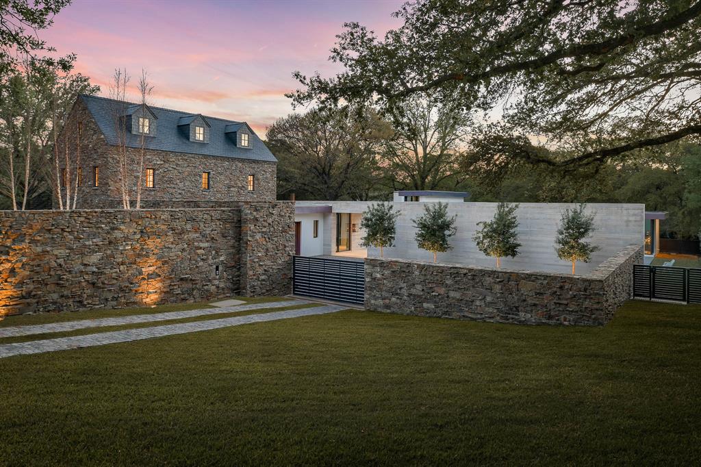 Introducing a sprawling residential masterpiece designed by Janson Luter Architects and brought to life by Sebastian Construction.  The property seamlessly melds classic Cotswold cottage inspiration with modern grandeur. Nestled on 1.44 park-like acres bordered by a meandering creek, the 4BD, 4.5BA residence results from the most talented tradespeople working with the finest materials. Stone walls, a gated motor court and manicured orchard invite you into a sophisticated home made for elegant entertaining. Formal living and dining rooms open to a great room wrapped with glass walls and a gourmet Bulthaup kitchen. Enjoy a serene owner's retreat with a spa bath and access to a secluded courtyard pool. Lavish guest suites, a study, fitness room, innumerable upgrades and smart home features make this a Dallas estate of distinction.