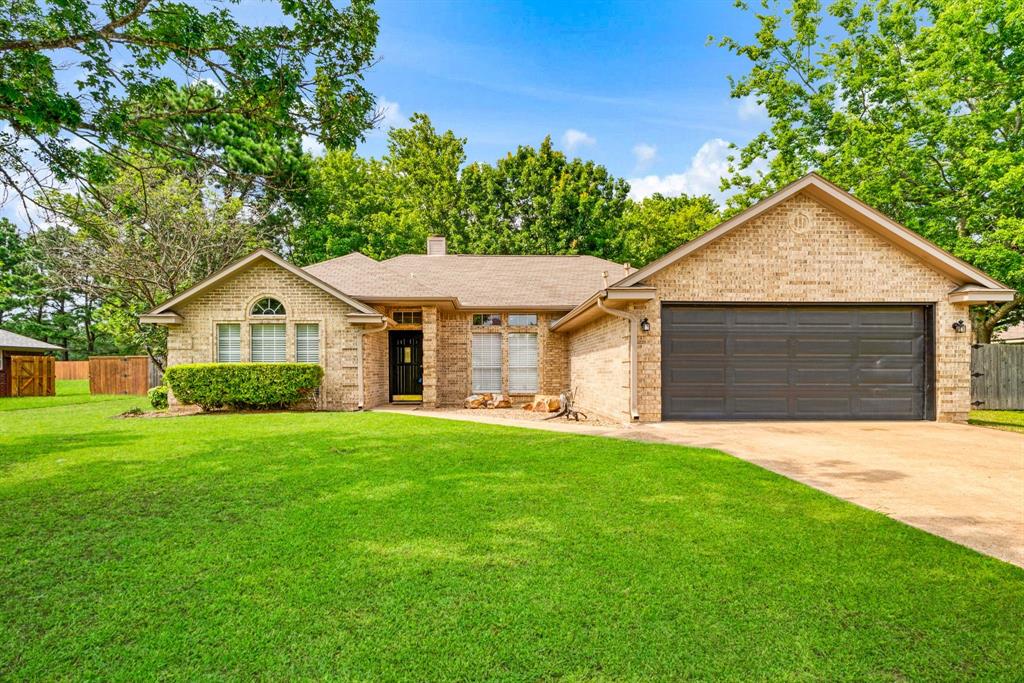 This freshly updated 3-bedroom, 2-bath home greets you with excellent curb appeal and a warm, welcoming presence. Inside, you’ll find a bright and spacious layout that feels open and inviting from the moment you walk in. The living room is a standout, featuring tall ceilings, a gas-log fireplace, and walls of natural light that pour in throughout the day. The updated kitchen offers modern stainless steel appliances and great functionality for everyday living and entertaining. Large primary suite with en-suite bathroom boasts a stunning tiled shower with frameless glass door, dual sinks, and two generous walk-in closets. The two additional bedrooms are well-sized and share a full bath. Step outside to your private backyard retreat — a large, fully shaded yard perfect for relaxing or play. Enjoy the spacious covered patio with stylish decorative lighting, an inviting fire pit area for cool evenings, plus a storage building and dedicated dog run. A 2-car garage completes the package. This move in ready home offers comfort, style, and outdoor living all in one fantastic package. Don't miss this one!