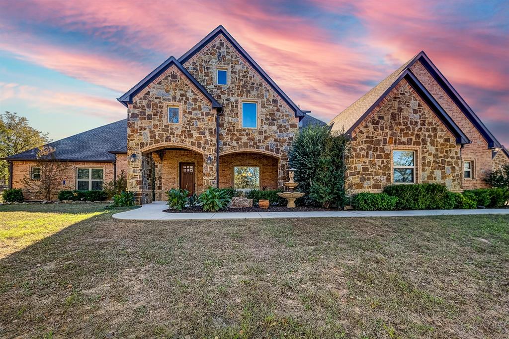 Large and expansive country estate with essentially 2 residences under 1 big roof. Located less than 1 hour north of downtown Fort Worth, this dream property is the perfect balance of peaceful rural living with no shortage of room to roam in a custom home loaded with extras. A classic stone ranch house with multiple covered porches and an elaborate pool and backyard area for entertaining. The main house features 6 large bedrooms and 4 full baths with an open layout from the kitchen to living room and large dining area. Appliances and the finish out features like a bar and wine rack are what you might expect for such a fine home. Upstairs is a large game room and a theatre room. There is a 6 ft wide hallway connecting the second living space with its own master bed and bath on the lower floor and second bedroom with a bath and loft upstairs. The high vaulted ceilings in the living area wouldn't be what you'd expect in a second living quarters. The back yard with a full outdoor kitchen pulls it all back together with a large pool and plenty of open space. Adjoining the backyard is a large dog run that can double as a small turnout for horses. A short distance behind the house is a 50 ft by 50 ft insulated shop with 2 large doors. The open space would be perfect for an RV, boat, tractor, or any other equipment you're needing to keep covered and don't want in your 5-car garage at the main residence. Being 42 acres in size, the rolling terrain with oaks, mesquite, cedars, and a variety of other tree species make the overall size seem much larger when wandering around. With this hill country feel, abundant wildlife frequent the property allowing for good hunting opportunities. For such outdoor enthusiasts, the property is in close proximity to the local attraction of lake Bridgeport where boating and fishing are always an option. Showing by appointment only.