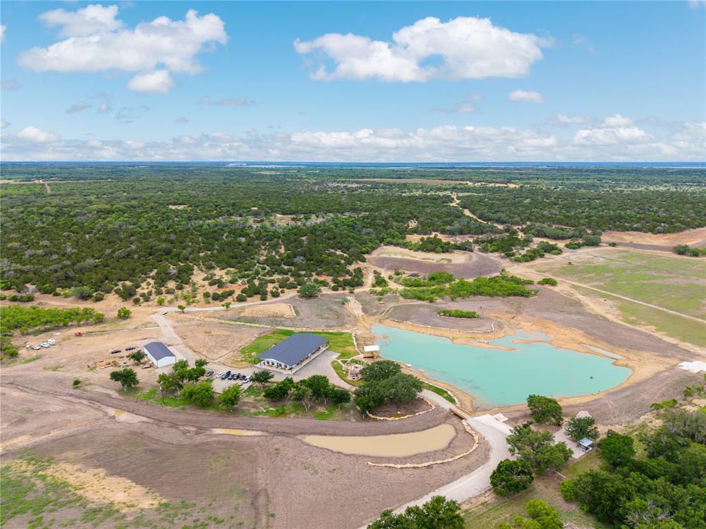 Discover a rare opportunity to own the 5K Ranch, a premier 835-acre high-fenced game ranch just 10 miles southwest of Brownwood. This turnkey Hill Country retreat blends luxury, recreation, and elite wildlife management across rolling terrain, heavy timber, and cultivated food plots.

The newly built 5,000 sq. ft. lodge features 8 bedrooms, 5.5 baths, a commercial kitchen, game room, and wraparound porches overlooking the main pond. Outdoor amenities include a custom silo bar, full outdoor kitchen, 3-hole golf course, rifle range, covered dock, and firepit.

The ranch is stocked with Approximately 225 Whitetails, 40 Gemsbok, 27 Oryx, 14 Addax, 12 Blesbok, 17 Ibex, 5 Nilgai, 9 Eland, 4 Wildebeest, Approximately 120 Axis, Approximately 112 Fallow, 6 Bison, Approximately 120 Blackbuck, 5 Transcaspian Urial, Approximately 32 Aoudad, 25 Red Stag, 4 Kudu, 4 Sable, 2 Bongo, 6 Waterbuck, & 2 Kangaroo — with exceptional genetics throughout.  11 Elevated Deer Blinds, 20 Corn Feeders, 12 Protein Feeders, and a 40 ton feed silo.

8 ponds, 2 water wells, and 3 high-fenced pastures support a thriving habitat. Includes a 2,400 sq. ft. shop with walk-in cooler, automatic gate, and paved FM frontage.

A true legacy property—ready to enjoy, manage, and share.