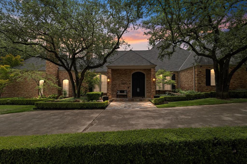 Sophisticated, Remodeled Traditional on a Corner Lot in Coveted Bent Tree. Nestled on a beautifully landscaped corner lot with a circle drive, this extensively updated home combines timeless elegance with modern luxury—all just minutes from Trinity Christian Academy. The spacious primary suite is a true retreat, featuring a fireplace, built-in study, dual spa-inspired bathrooms with quartz countertops, separate his-and-her toilets (one with bidet), dual showers, and a freestanding soaking tub. Power shades add extra privacy and comfort. The light-filled living areas showcase new hardwood floors, fresh interior and exterior paint (2018), updated can lighting, and an open-concept layout perfect for both entertaining and everyday living. The chef’s kitchen is fully updated with Wolf appliances, Taj Mahal quartzite countertops, Ann Sacks backsplash, Sub-Zero refrigerator, soft-close cabinetry, under-cabinet lighting, hot water dispenser, and dual pull-out trash drawers, all designed with both beauty and function in mind. Enjoy indoor-outdoor living in the screened-in porch with fireplace and heaters, or step into the lush backyard oasis featuring pebble tech pool and spa (resurfaced 2018), turf with putting green (2021), Lynx built-in grill, mosquito system, and two tranquil fountains. Control your pool and spa from your phone with the Aqualink app and enjoy music from built-in Sonos speakers. All five bedrooms are conveniently located on the main level, while a large bonus game room with a full bath and new windows (added in 2018) sits upstairs. One of the bedrooms features a custom built-in dresser and shelving, along with a private office or study space. The home also offers extensive storage, a huge walk-in pantry, updated utility room, new water heater (2023), 3 new HVACs (2018), and a Rachio sprinkler system (2025) for smart lawn care. With every detail thoughtfully renovated, this home offers move-in-ready comfort in one of Dallas’ most desirable neighborhoods.