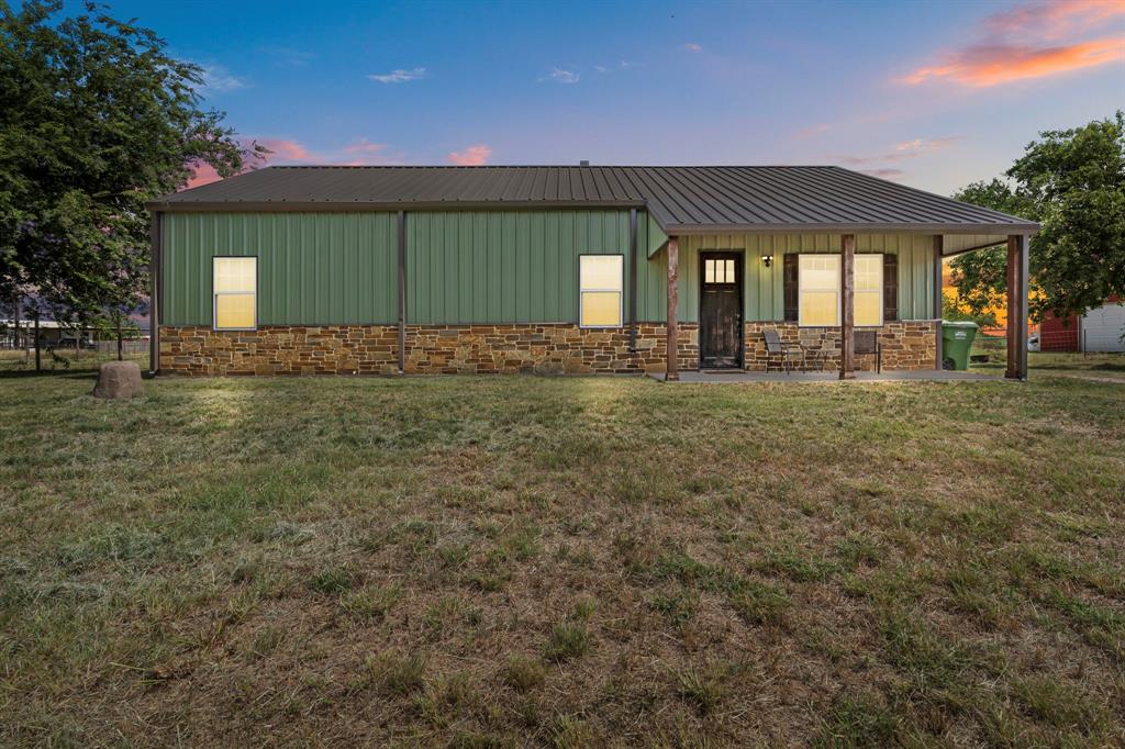 GET EXCITED! You'll love this rustic style barndominium! It features a completely open floor plan that blends rustic charm with elegant touches. The family room boasts vaulted ceilings with cedar plank inlays, a stone fireplace, and stained concrete floors. You'll also find custom cabinetry, granite countertops, and both decorative and recessed lighting throughout. A custom spiral staircase leads to an 800 sq ft flex space, perfect for a media room or whatever suits your needs. Situated on over half an acre, the property also includes a 24x24 pad, ready for your new shop. Fresh paint throughout home as well. Come see this Decatur charm! You'll thank yourself for getting an offer in early!